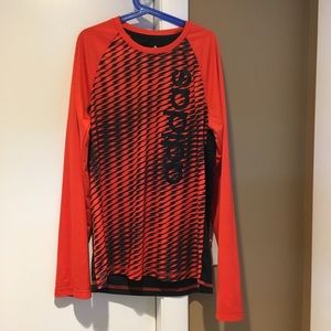 Orange adidas base layer.